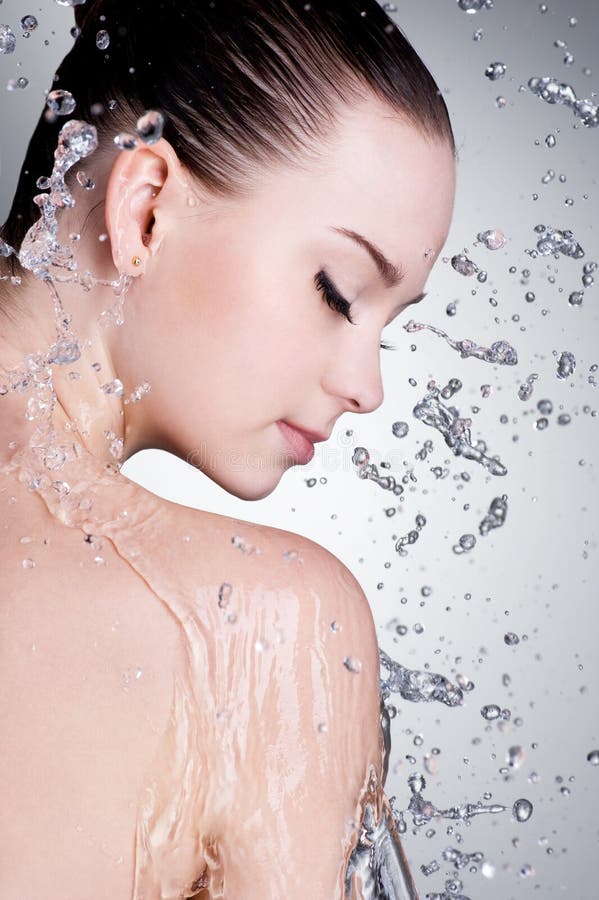 Splashes And Drops Of Water Around The Female Face Royalty Free Stock