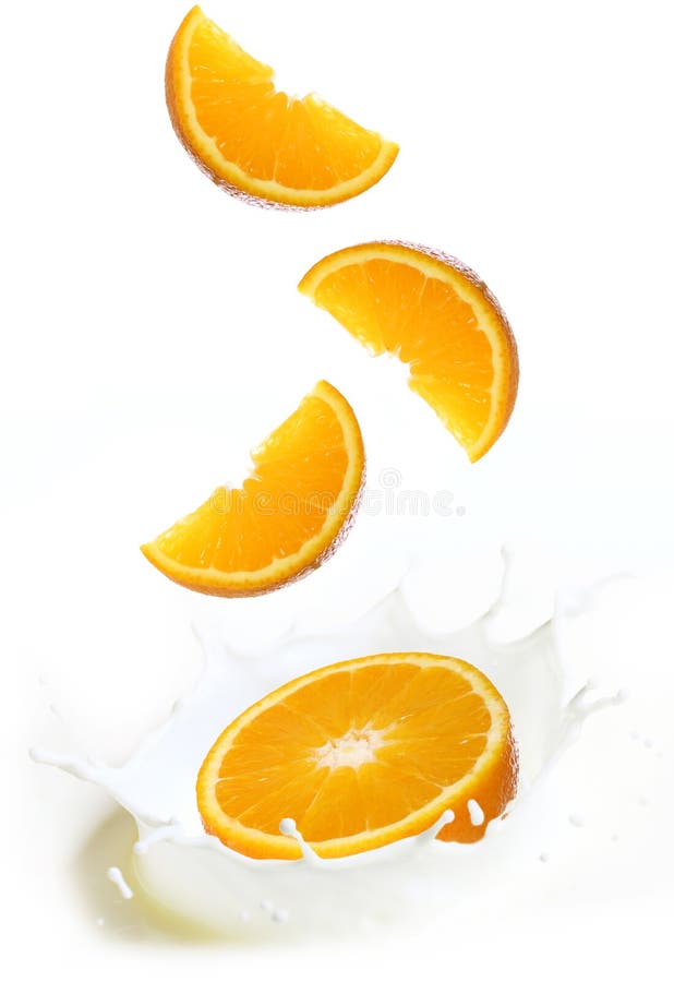 Splashes of milk with slices of orange fruit