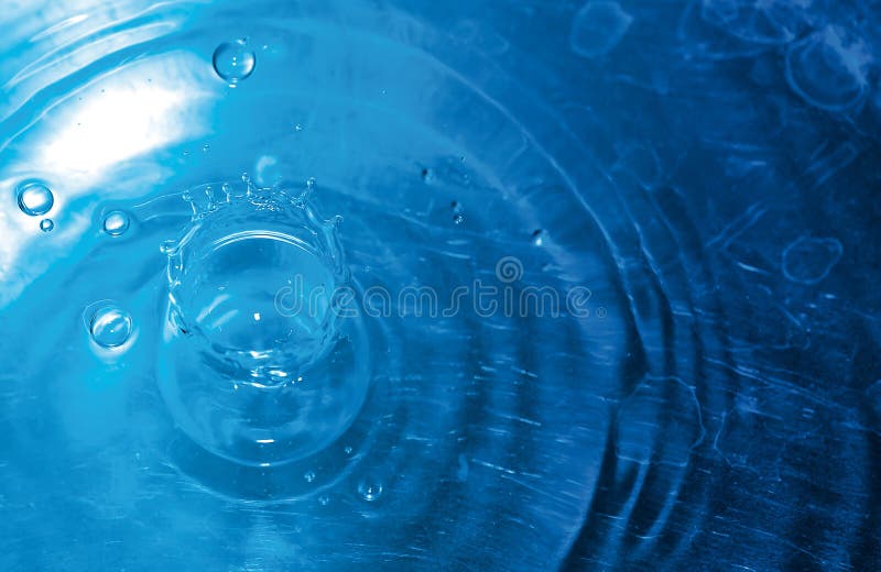 Splashing water drops blue background