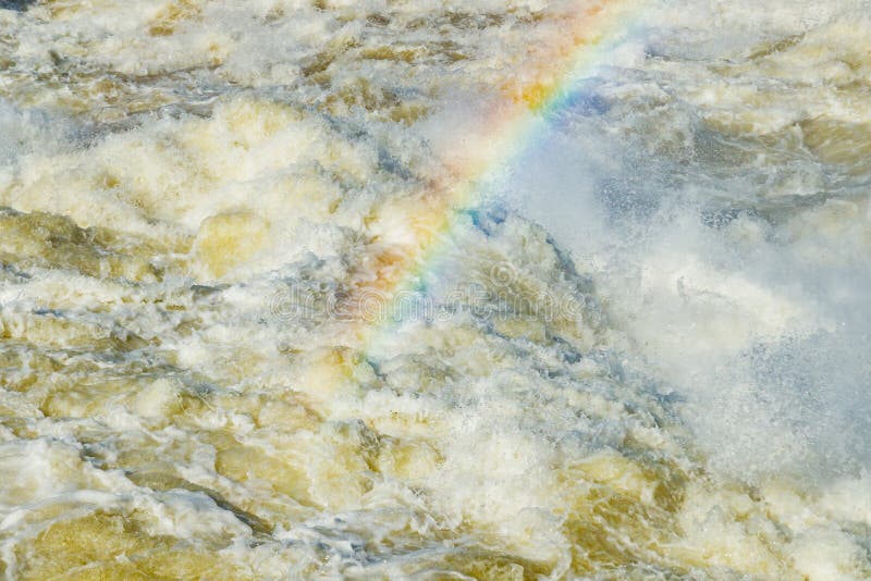 Splashing water waves with rainbow on the fast river stock images