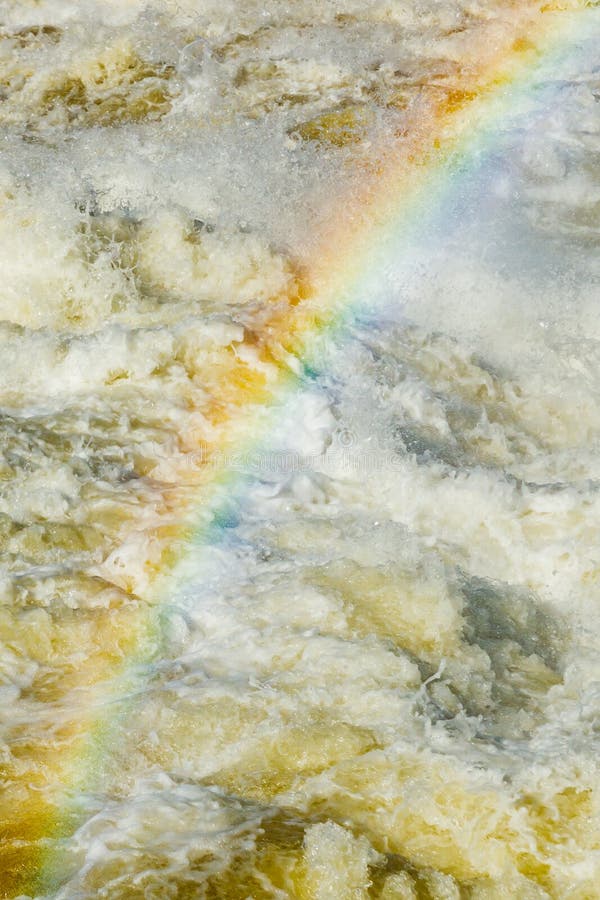 Splashing water waves with rainbow on the fast river stock photos