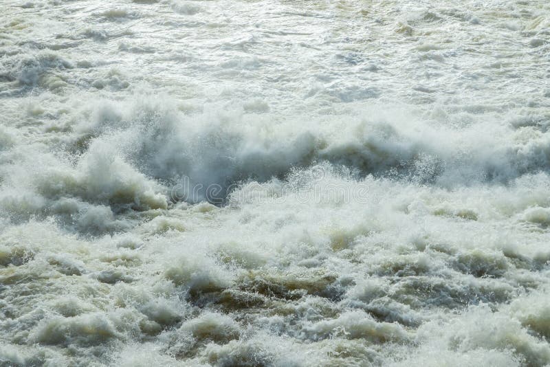 Splashing water waves on the spring fast river stock image