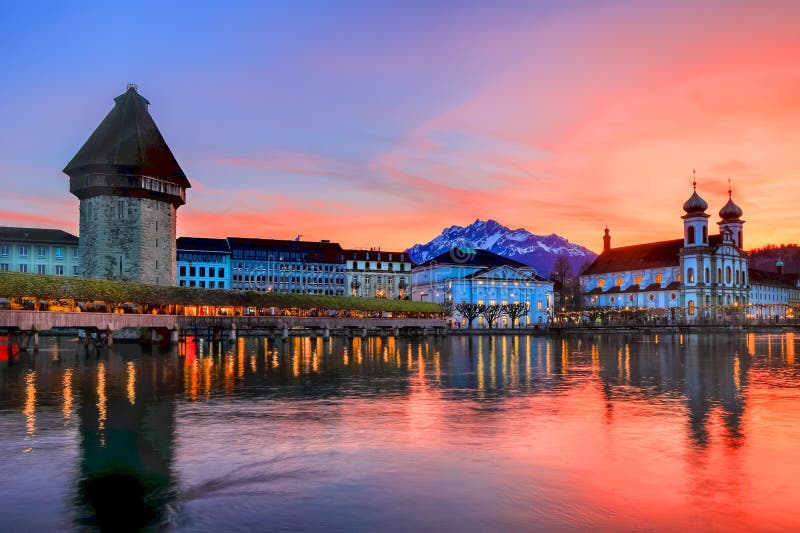 Splendid sunset over the Luzern Kappelbrucke bridge and Jesuten church with Pilatus mountain