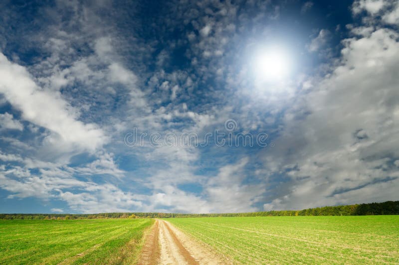 Splendid cumulus clouds and autumn field.