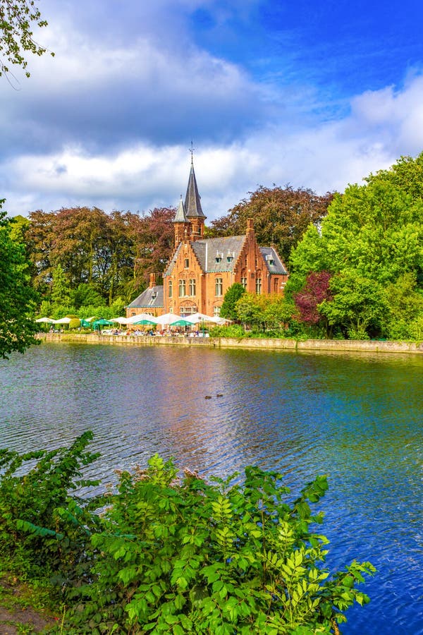 Picturesque castle on Minnerwater lake in Minnerwater park -Tranquil public green space featuring Minnewater Lake & the gatehouse of a demolished castle.Bruges is the capital and largest city of the province of West Flanders in the Flemish Region of Belgium,August 7th 2016. Picturesque castle on Minnerwater lake in Minnerwater park -Tranquil public green space featuring Minnewater Lake & the gatehouse of a demolished castle.Bruges is the capital and largest city of the province of West Flanders in the Flemish Region of Belgium,August 7th 2016