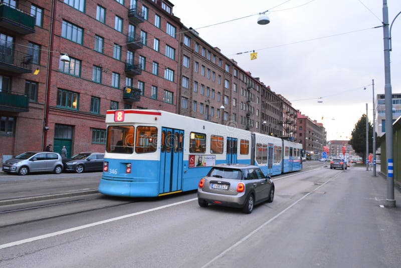 Splendido tram di passaggio vicino a mini Cooper nella città svedese di gothenburg immagine stock