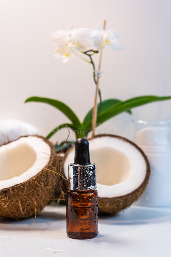 Split Coconuts with Coconut Essential Oil. Coconut Serum for the Face