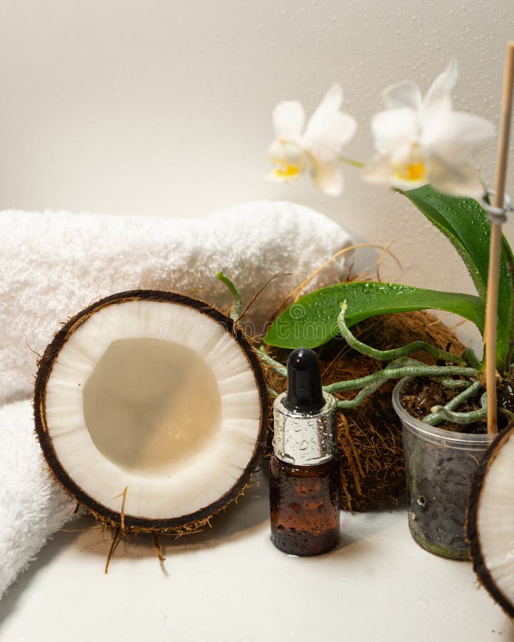 Split Coconuts with Coconut Essential Oil. Coconut Serum for the Face