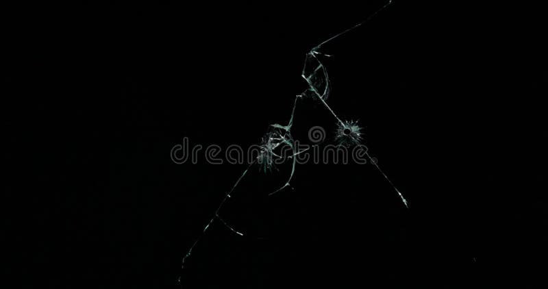 Broken cracks glass fracture effect texture isolated abstract black background. Bullet cracked window with big hole screen mirror weapon shot. Broken cracks glass fracture effect texture isolated abstract black background. Bullet cracked window with big hole screen mirror weapon shot.