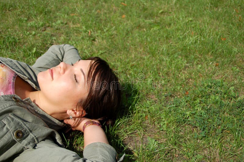 Women rest on the grass. Women rest on the grass