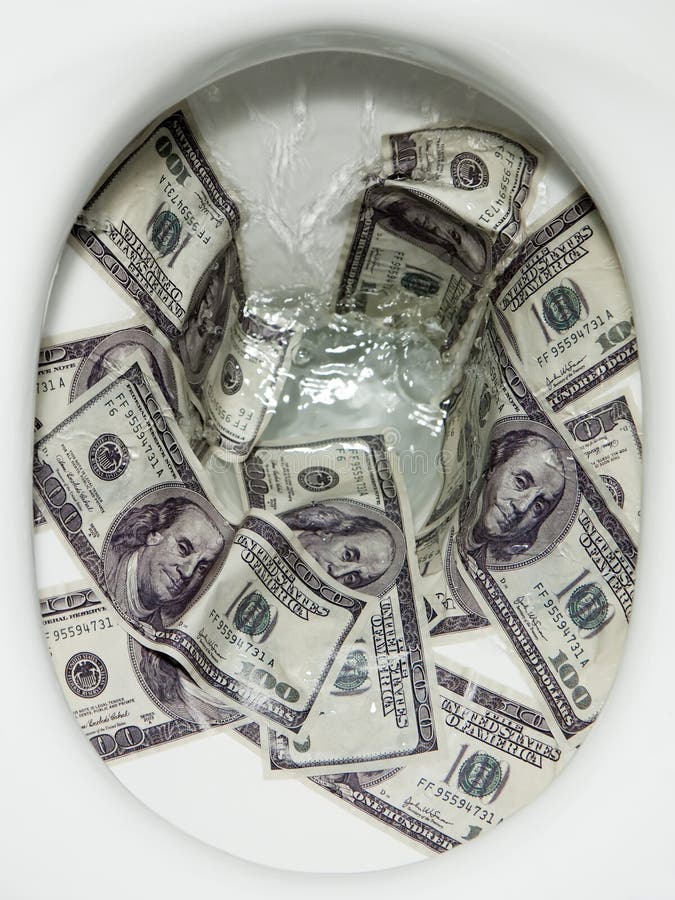 Flushing dollar bills into a toilet bowl. Flushing dollar bills into a toilet bowl