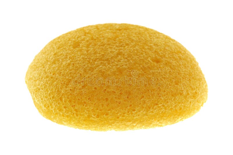 A round yellow natural facial Sponge made of vegetable fiber, Konjac, isolated on white