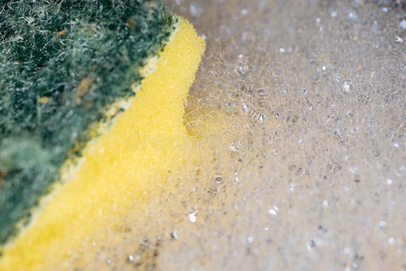 A Sponge Surrounded by Washing Up Bubbles from Washing Up Liquid Using Selective Focus Stock