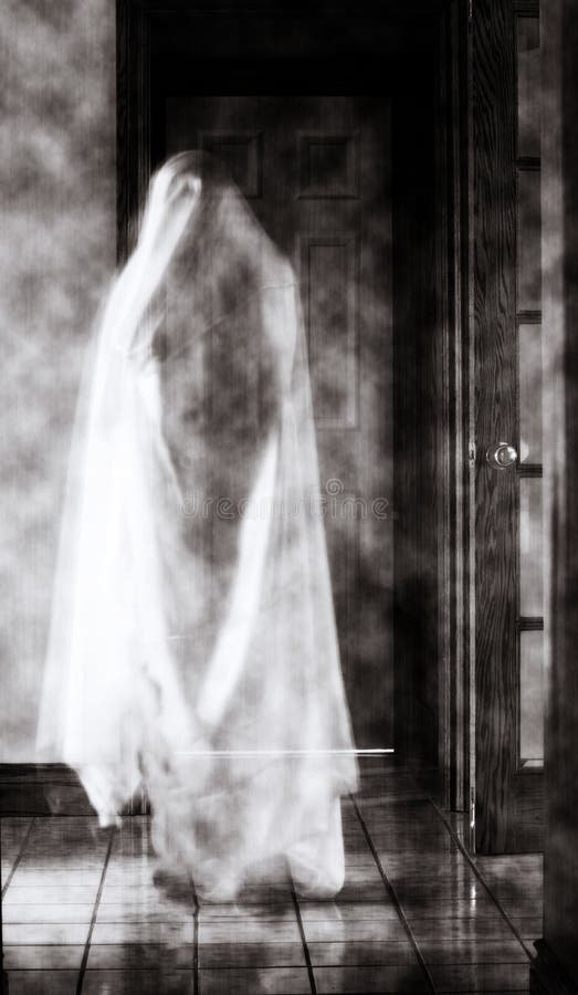 A spooky ghost in a hallway royalty free stock photo