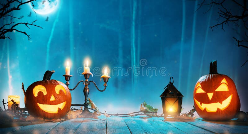 Spooky halloween pumpkins in forest. Scary halloween background with free space for text.