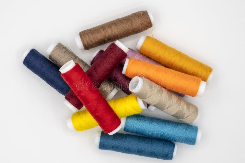 Spool of thread many of different colors isolated on white stock photos