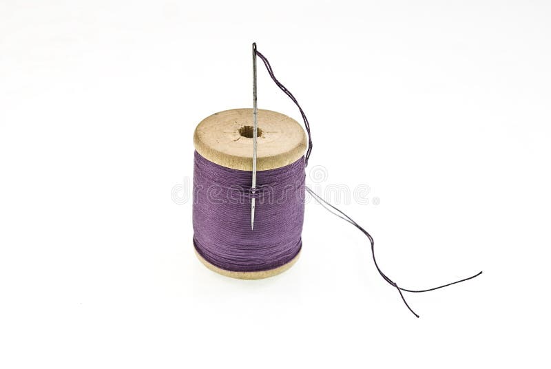 A spool of thread with a needle in it