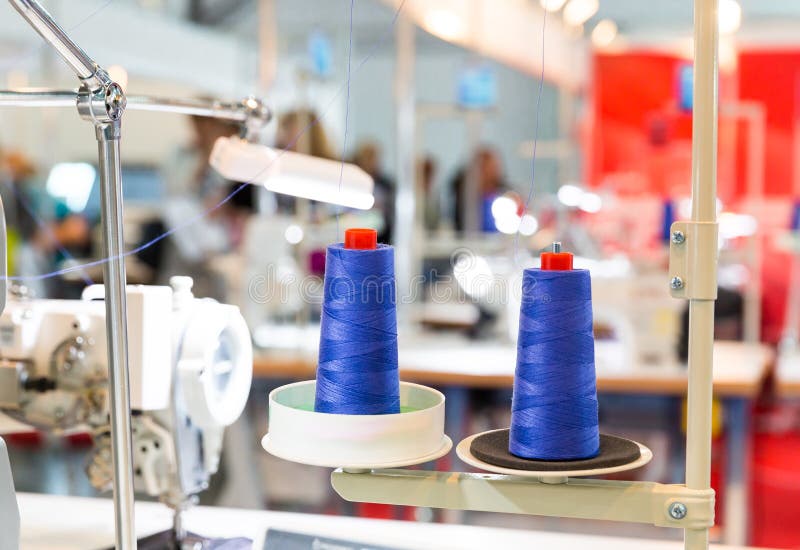 Spools of blue threads on sewing machine, factory stock photography Spools of blue threads on sewing machine, factory stock photography