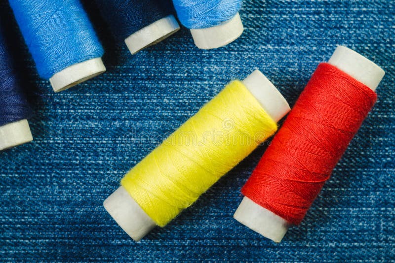 Spools of Blue, Yellow and Red Sewing Thread on Blue Denim Stock Image Image of group, denim