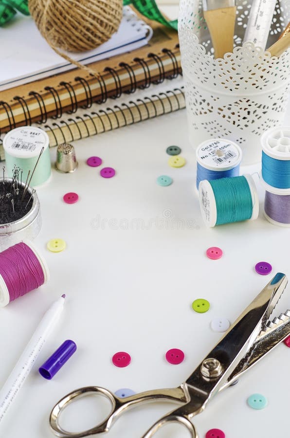 Spools of Thread and Basic Sewing Tools Including Pins, Needle, a Thimble, and Tape Measure