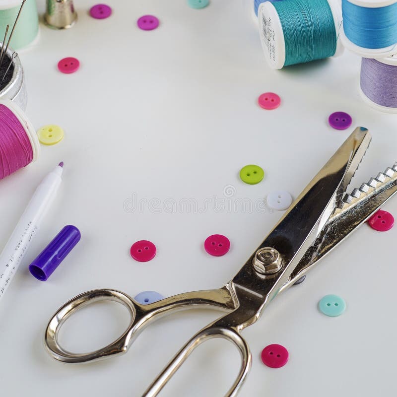 Spools of Thread and Basic Sewing Tools Including Pins, Needle, a Thimble, and Tape Measure