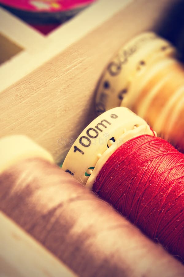 Spools of thread in a retro vintage style. Vertical image. Spools of thread in a retro vintage style. Vertical image.