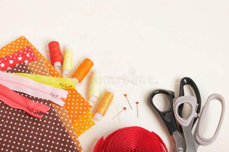 Spools of Thread, Scissors, Fabrics, Zipper and Velcro Tape on the