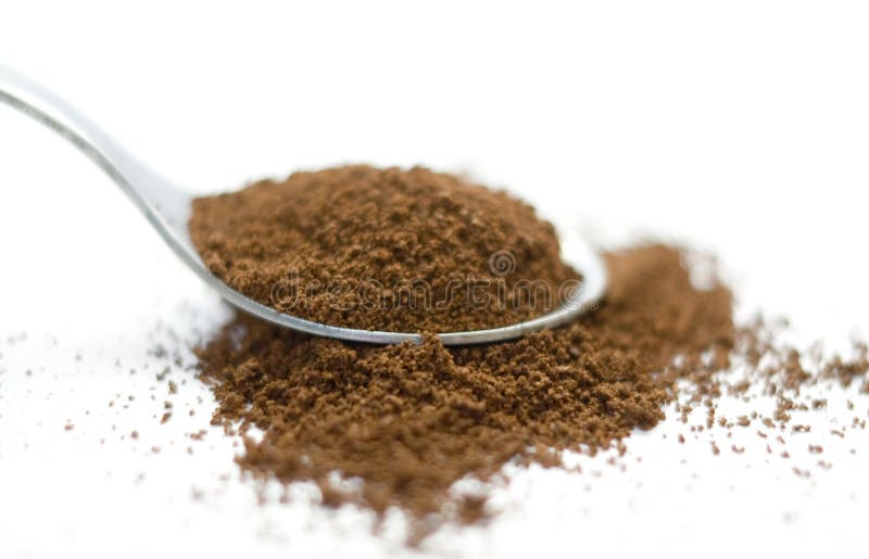 Spoon with coffee isolated on a white background.