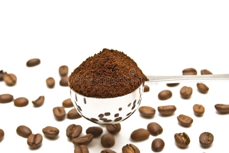 Spoon of coffee on a background grains