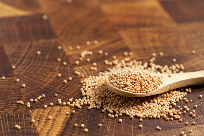 Spoon Full of Mustard Seeds on a Butcher Block Stock Photo Image of