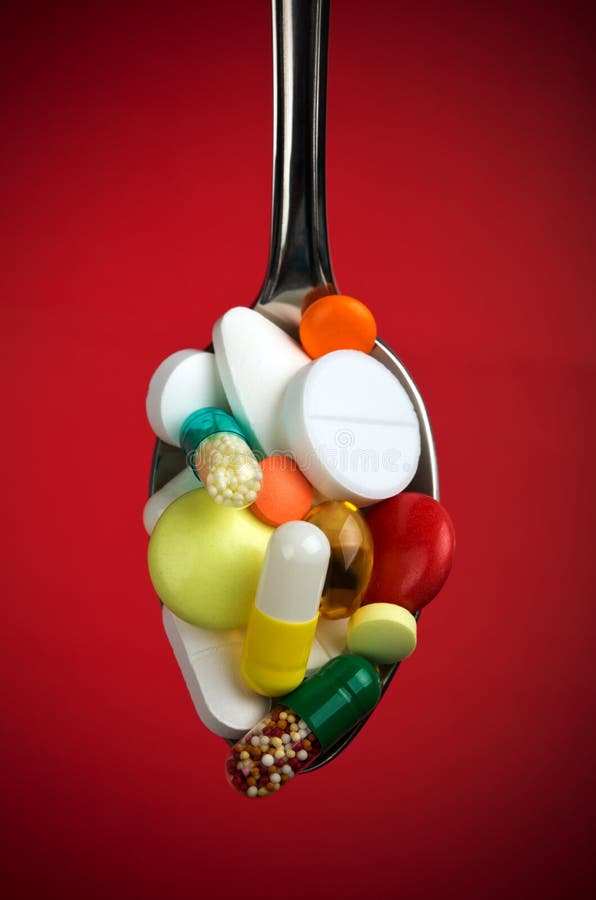 Spoon full of various pills