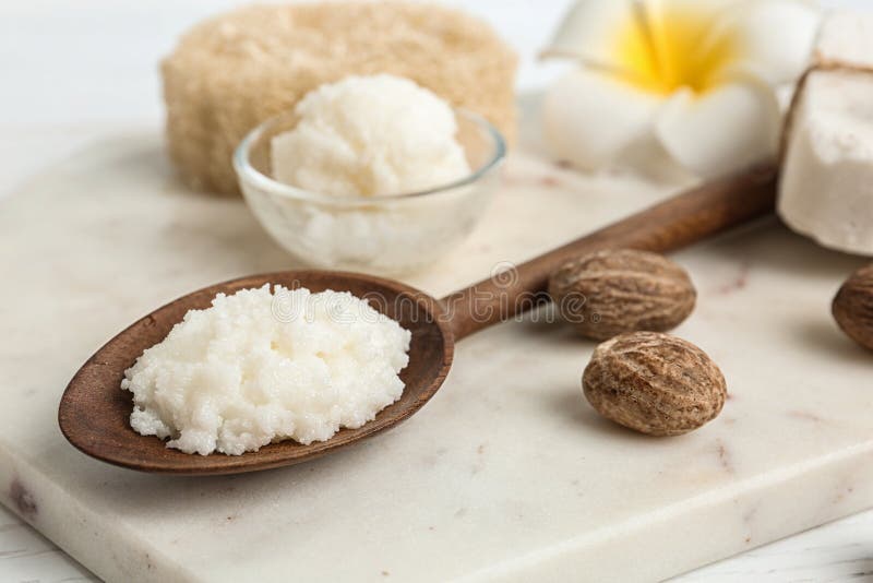 Spoon with Shea butter and nuts royalty free stock image