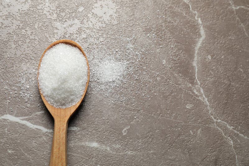 Spoon of White Sugar on Marble Table. Space for Text Stock Photo