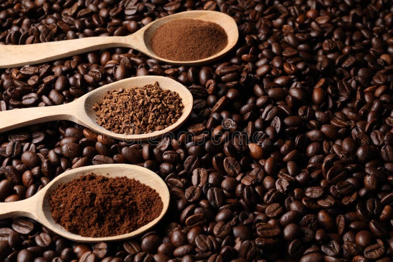 Spoons with Different Types of Coffee on Roasted Beans. Space for Text