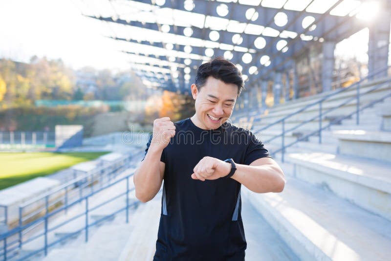 Sport Asian Man Looking Smart Watch at Modern Track. Man Runner Using ...