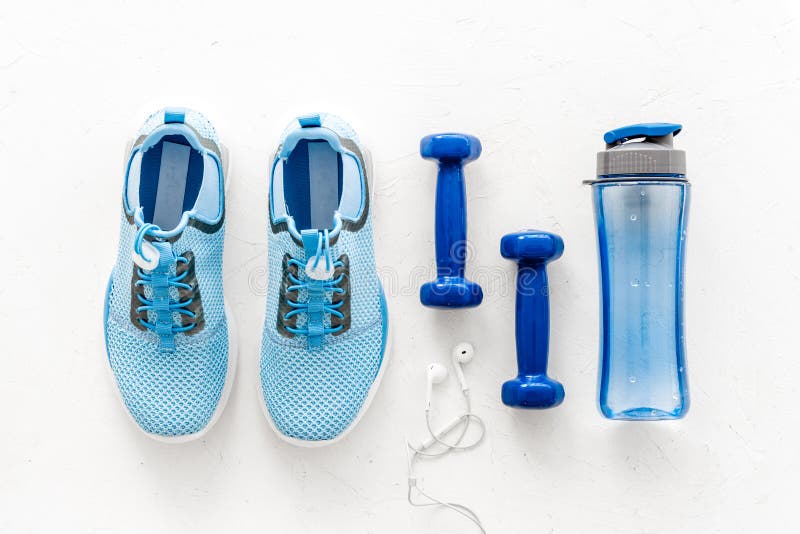 Sport equipment. Sneakers, dumbbells and water on white table top view flat-lay. Sport equipment. Sneakers, dumbbells and water on white table top view royalty free stock image Sport equipment. Sneakers, dumbbells and water on white table top view flat-lay. Sport equipment. Sneakers, dumbbells and water on white table top view royalty free stock image