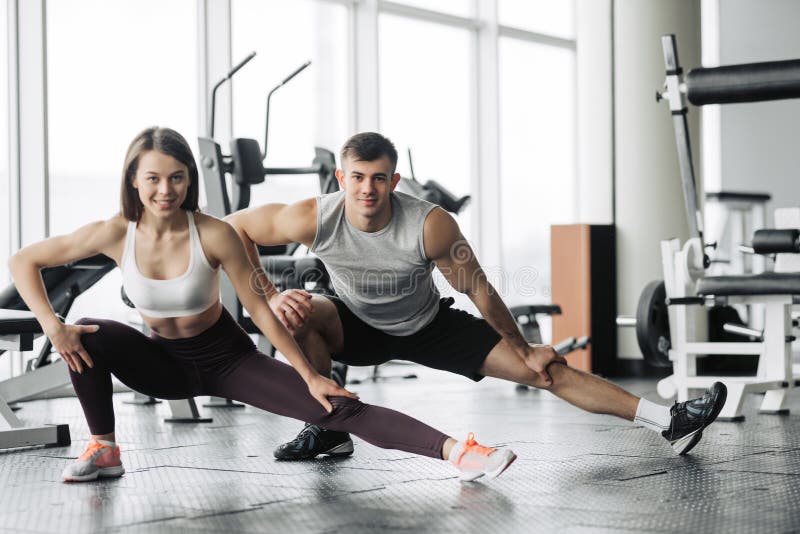 Sport Fitness Lifestyle And People Concept Smiling Man And Woman Stretching In Gym Stock Photo Image Of Handsome Happy