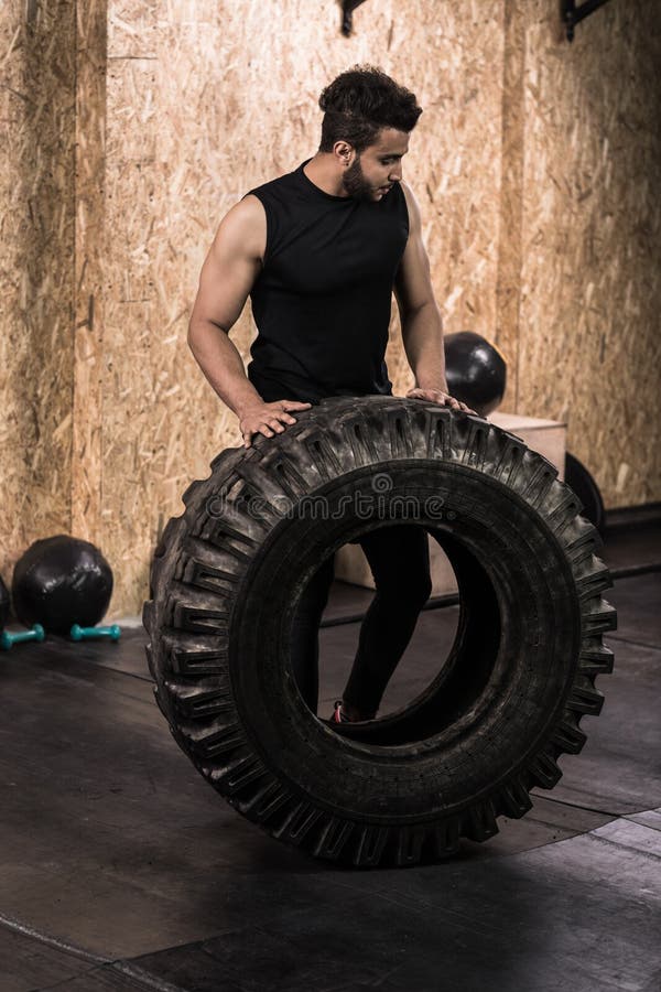Sport Fitness Man Flipping Wheel Tire Crossfit Training stock images Sport Fitness Man Flipping Wheel Tire Crossfit Training stock images