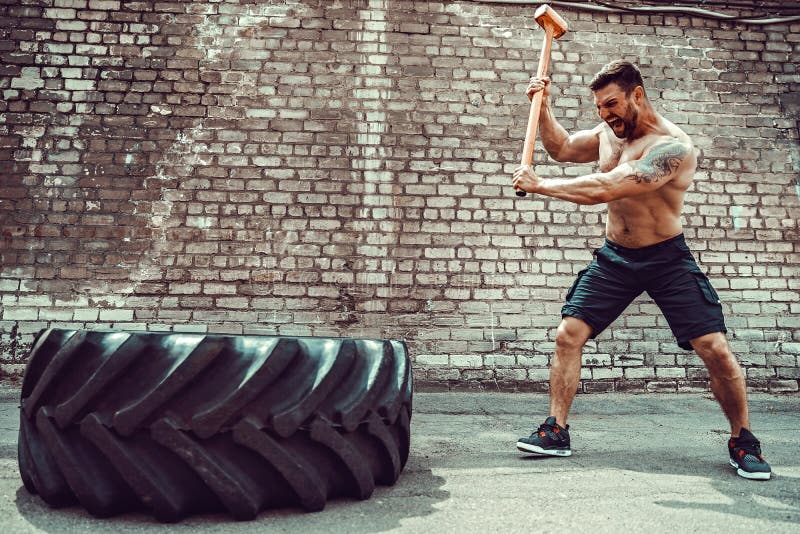Sport Fitness Man Hitting Wheel Tire with Hammer Sledge Crossfit Training. Stock Photo - Image of cross, athletic: 122649648