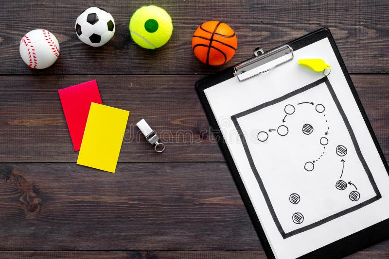 Sport judging concept. Sport game referee. Tactic plan for game, balls, red and yellow cards, whistle on wooden stock photography Sport judging concept. Sport game referee. Tactic plan for game, balls, red and yellow cards, whistle on wooden stock photography