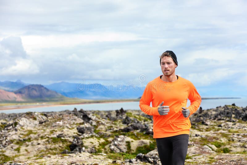 Sport running man in cross country trail run. Male runner exercising and training outdoors in beautiful mountain nature landscape on Snaefellsnes, Iceland. Sport running man in cross country trail run. Male runner exercising and training outdoors in beautiful mountain nature landscape on Snaefellsnes, Iceland.