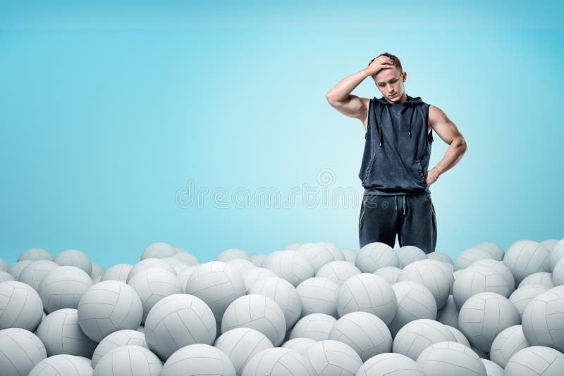 Sport man thinking over white volleyball balls on blue background royalty free stock photography Sport man thinking over white volleyball balls on blue background royalty free stock photography