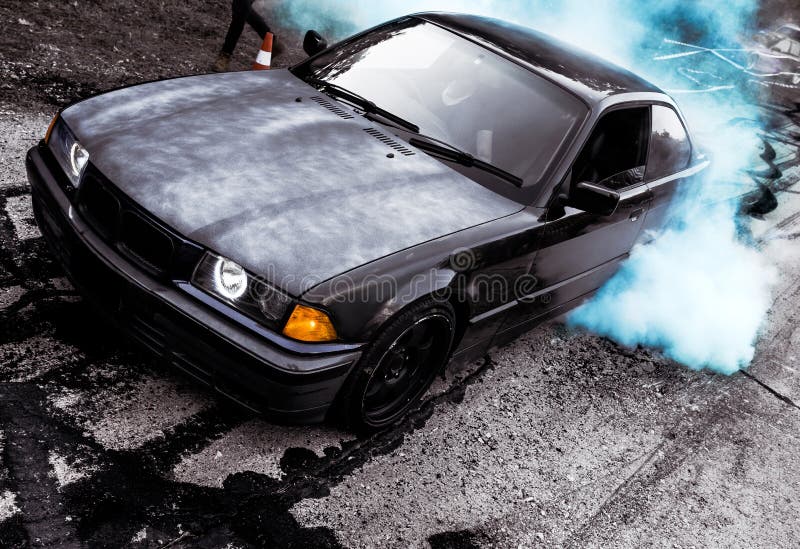 Moldova 25.09.2019. Sport modern Stance E36 BMW Car racing car drifting with smoke drift burnout, Blue clouds with