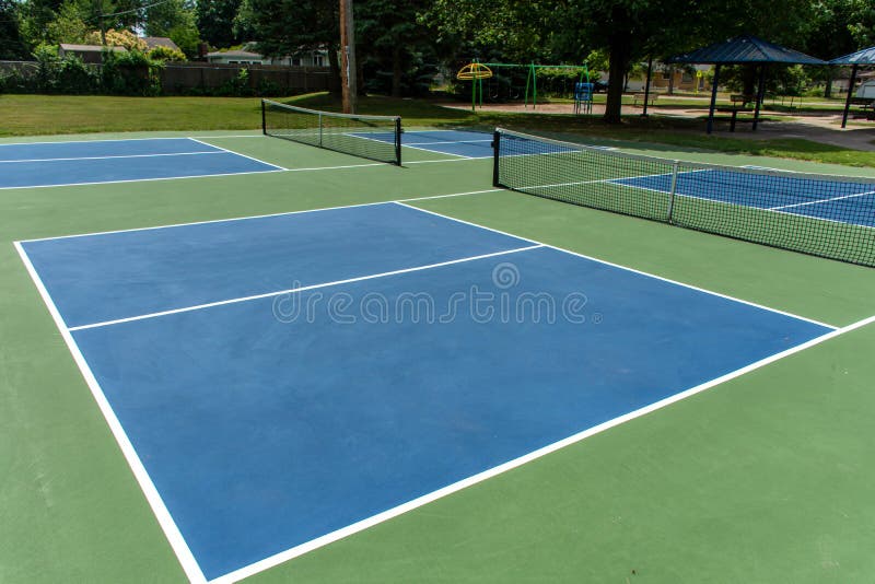 Recreational sport of pickleball court in Michigan, USA looking at an empty blue and green new court at a outdoor park. Recreational sport of pickleball court in Michigan, USA looking at an empty blue and green new court at a outdoor park.