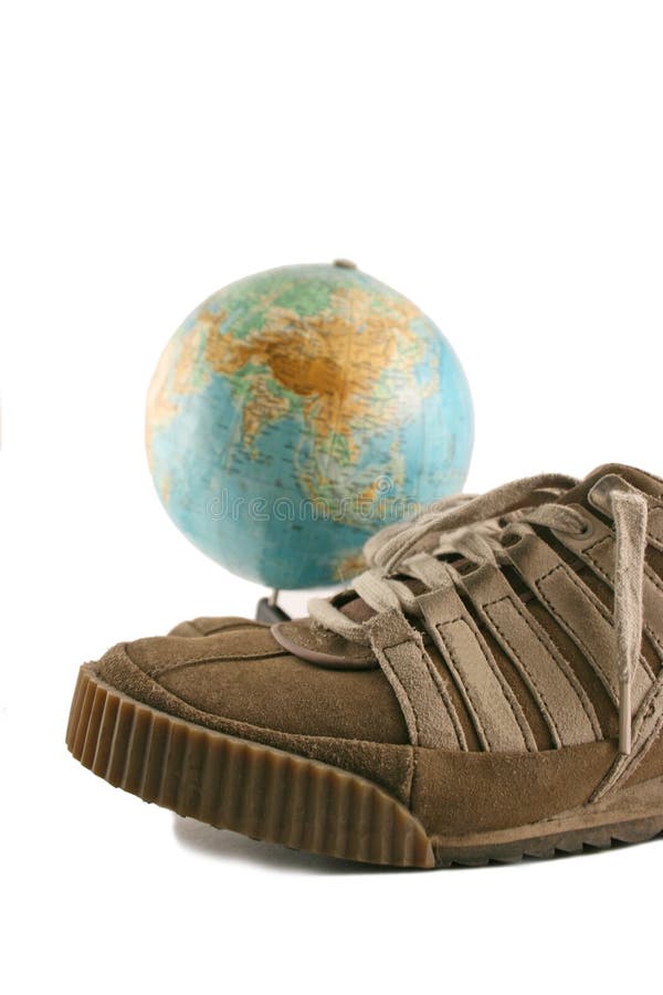 Sport shoes next to a globe