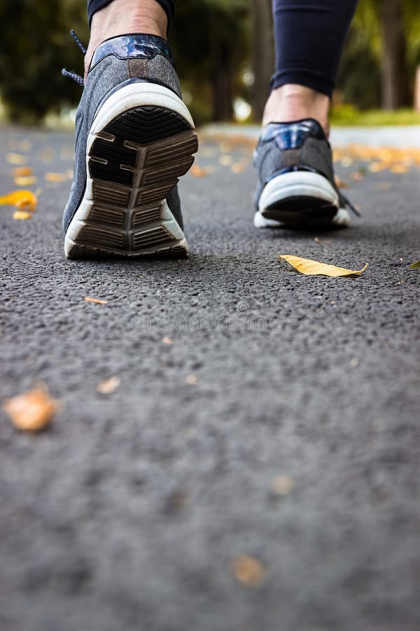 Sport shoes. A woman on the pavement. Cardio workout.