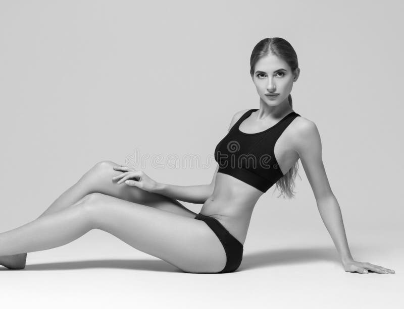 Sport. Woman sport body strong and beautiful black and white. Studio shot. Black and white. Studio shot.