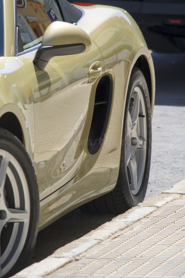Detail of the bodywork of a sports car parked at the side of the road. Detail of the bodywork of a sports car parked at the side of the road