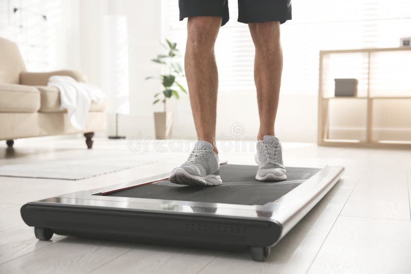 Sportieve man traint thuis op een loopband, close-up royalty-vrije stock afbeeldingen