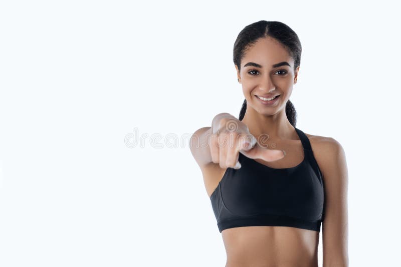 Sportiva sorridente felice che vi indica immagini stock libere da diritti Sportiva sorridente felice che vi indica immagini stock libere da diritti
